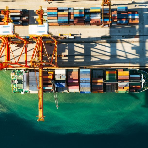 Aerial view of containers loading and unloading to the ship in the sea port. Logistic and