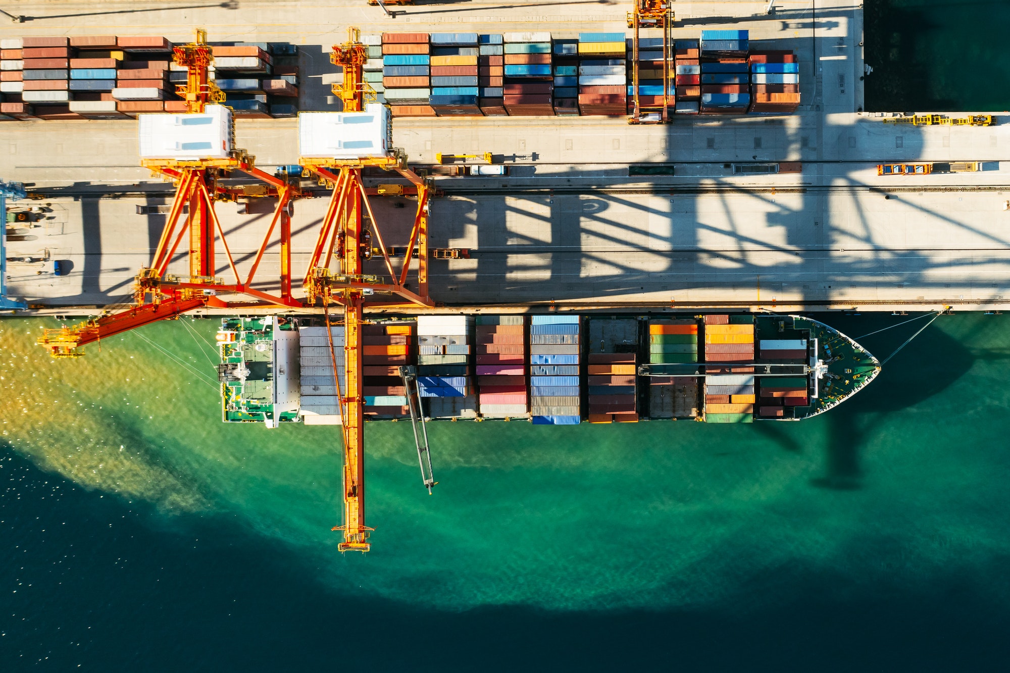 Aerial view of containers loading and unloading to the ship in the sea port. Logistic and