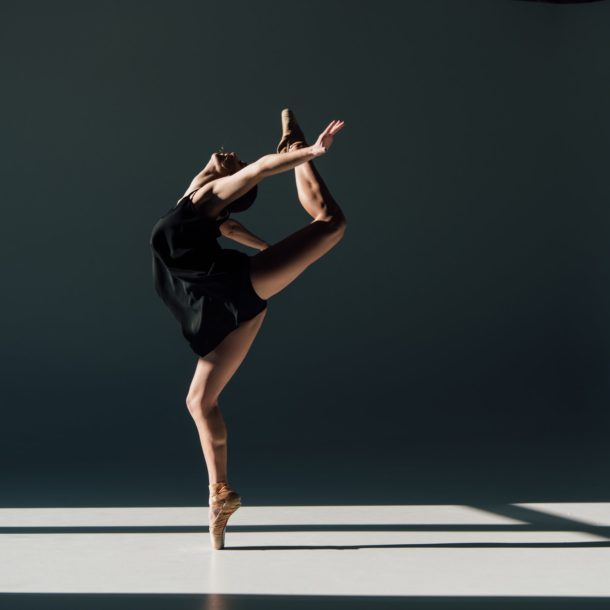 beautiful young ballerina dancing in sunlight