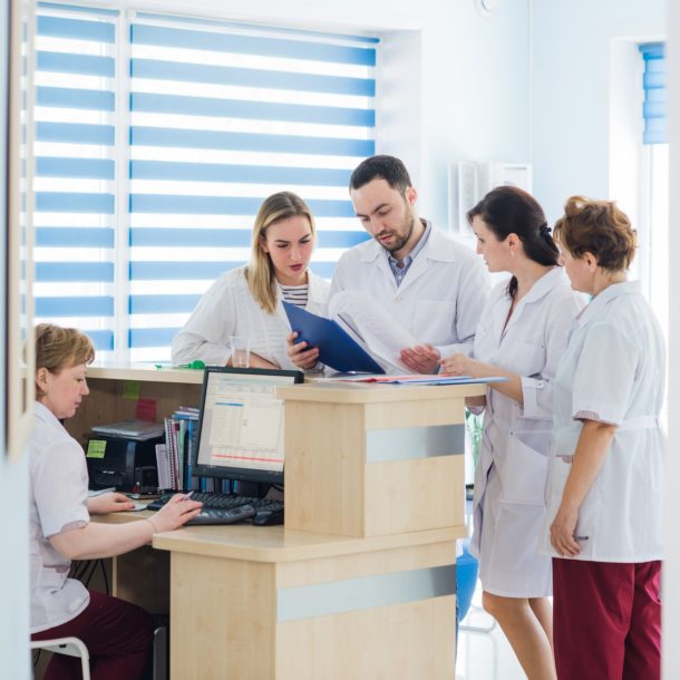 Doctor and receptionist at reception in a hospital