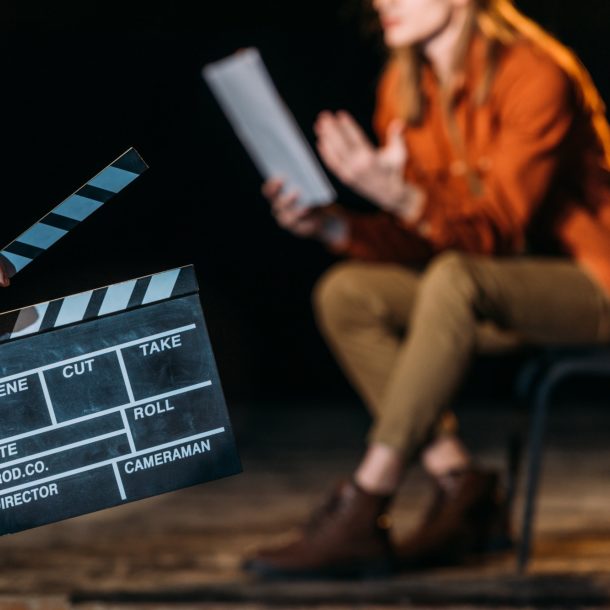 selective focus of actor with clapboard in front