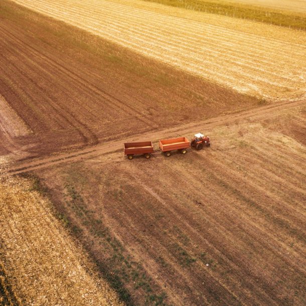 Aerial view of agricultural tractor in the field