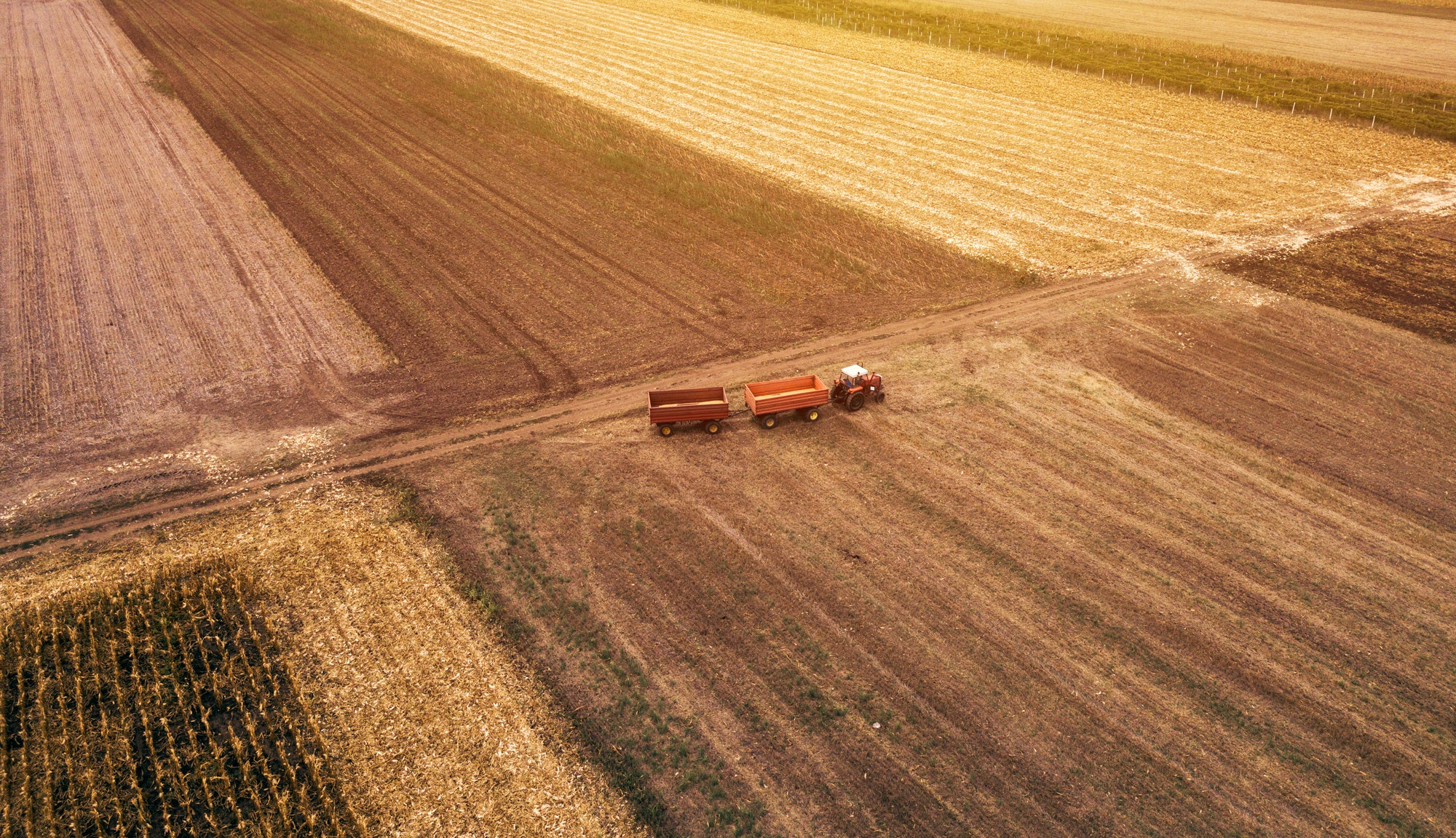 Aerial view of agricultural tractor in the field