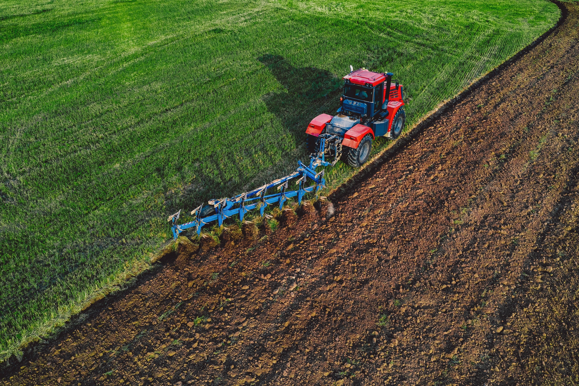Aerial View of Tractor Plowing Field