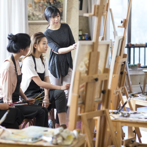 Art teacher with young women in studio