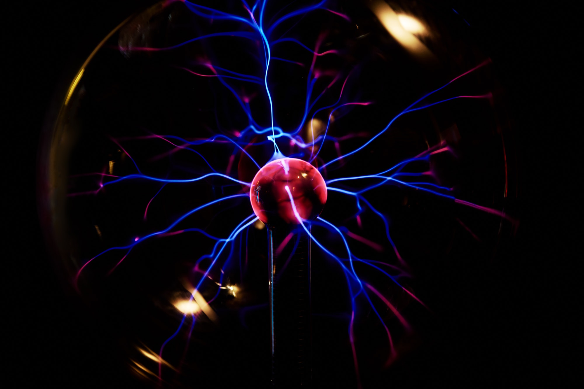 Plasma ball with energy rays on dark background