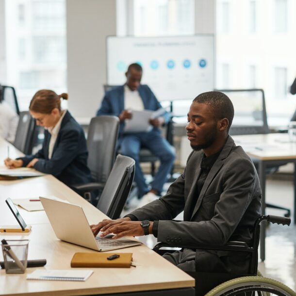 Businessman using Wheelchair in Office