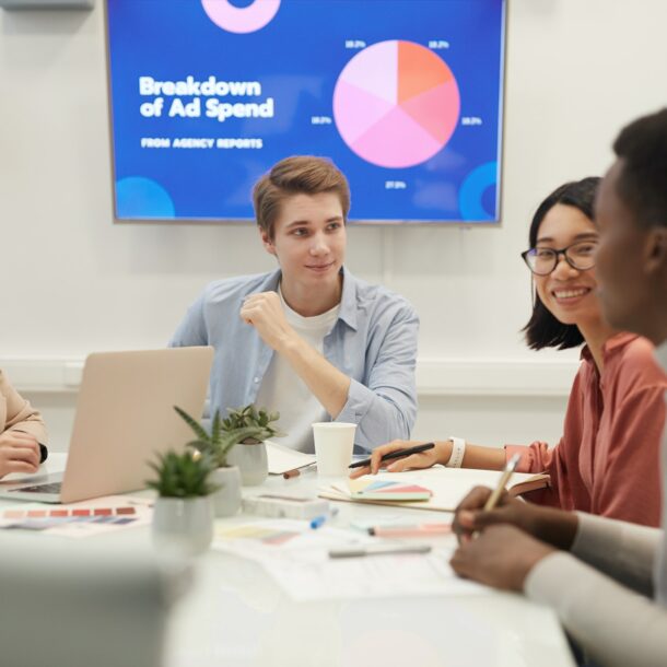 Young People Discussing Marketing in Meeting