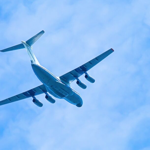 Airplane in blue sky. Air cargo transportation. Plane is flying